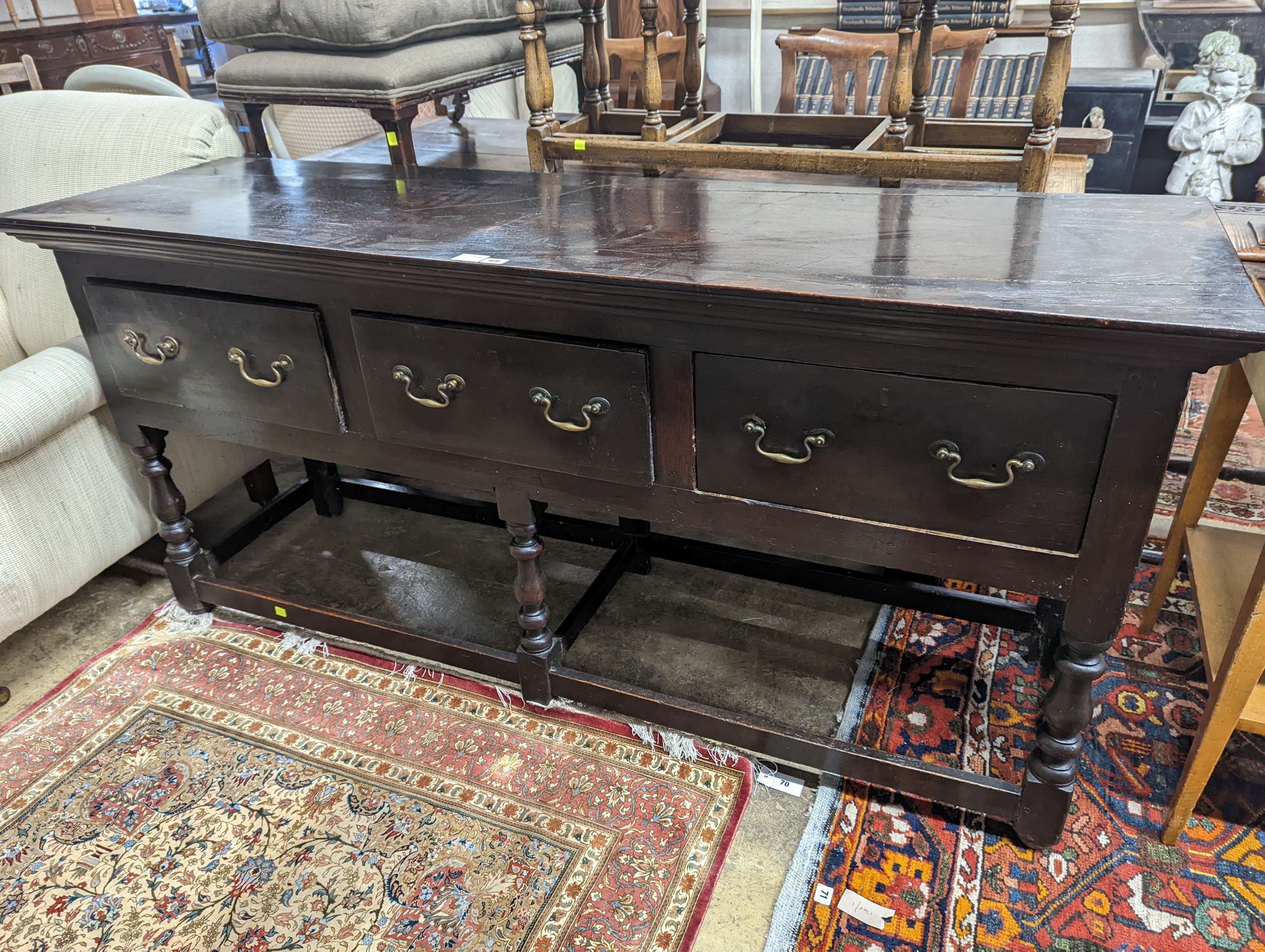 A George III oak low dresser base, length 175cm, depth 51cm, height 82cm